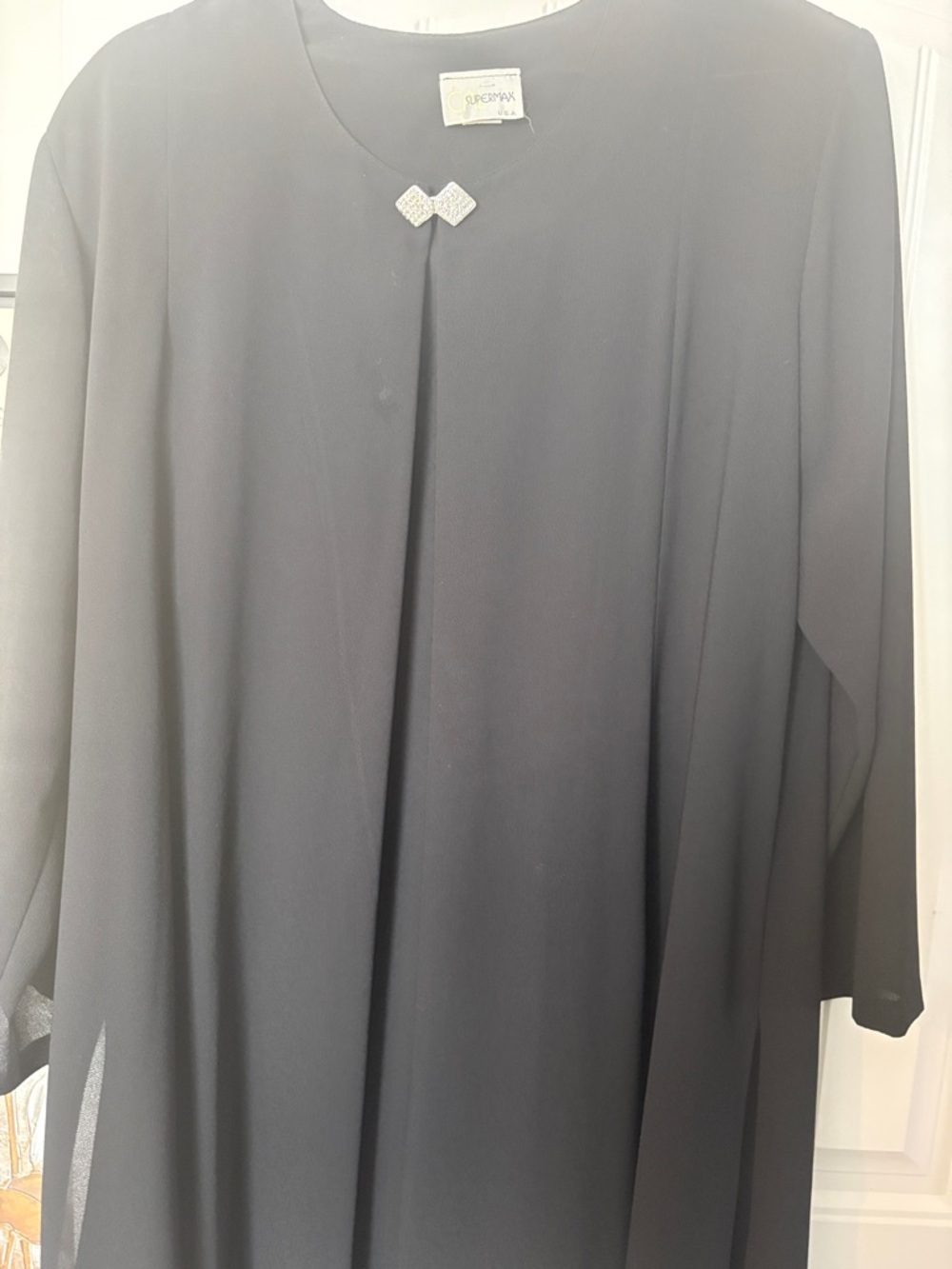 Black Flowing Long Sleeve Long Duster with Decorative Brooch.